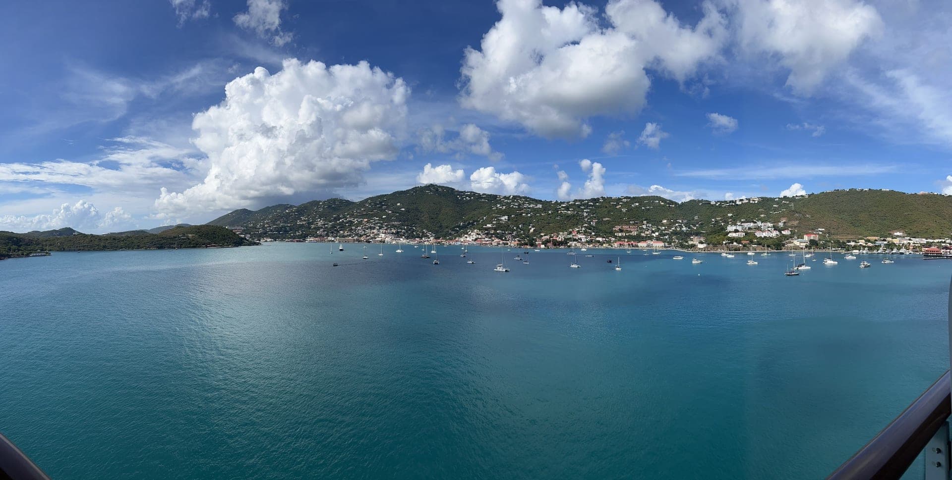Caribbean harbor with sailboats viewed from a cruise ship balcony