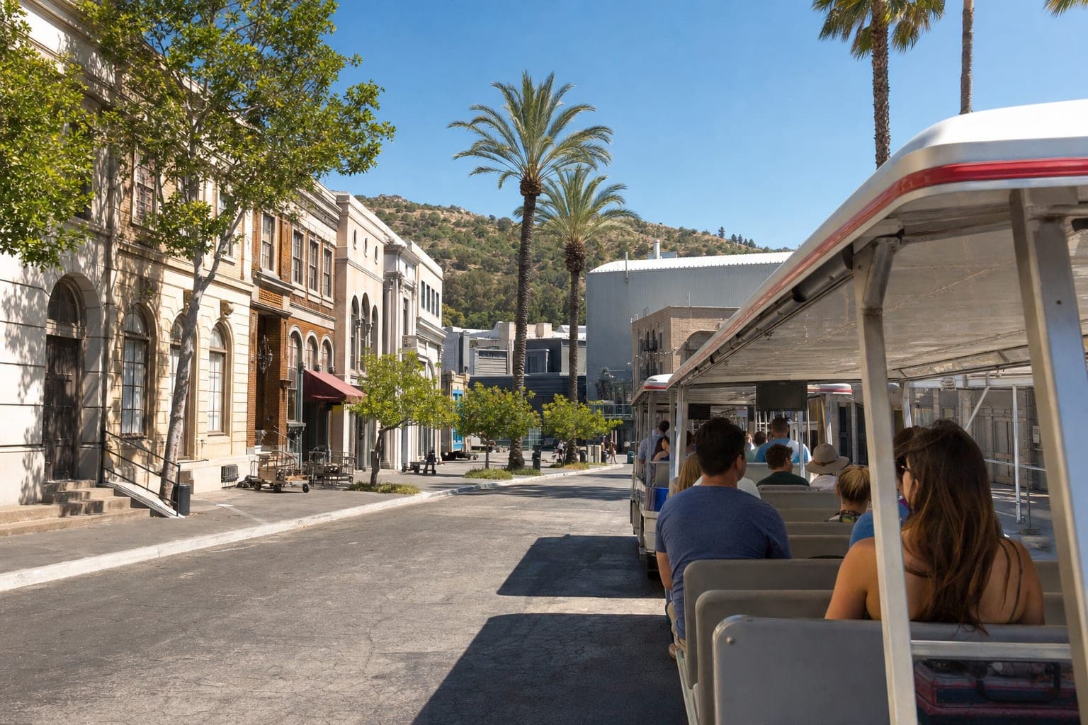 Hollywood movie studio backlot tram tour with palm trees and California hills